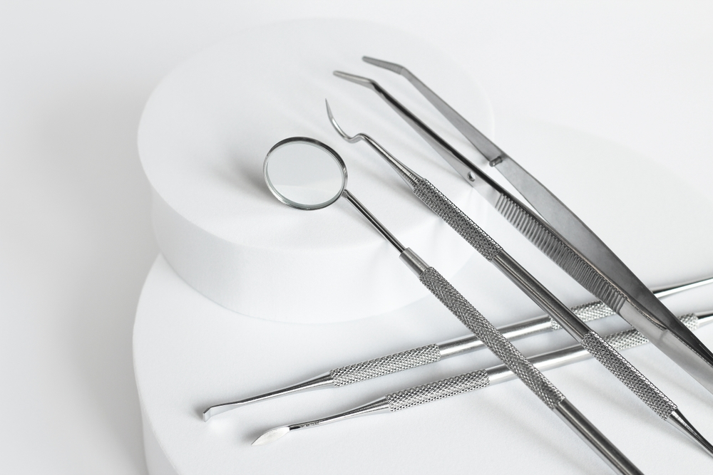 Pictures of dental cleaning utensil tools lined up with white background